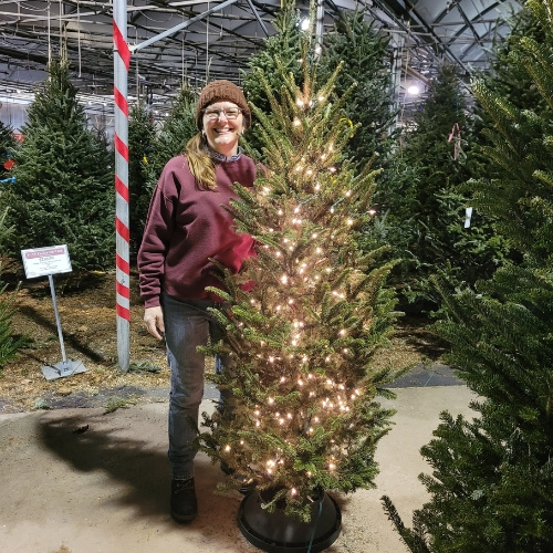 Heinz Brothers staff standing next to a decorated Christmas tree