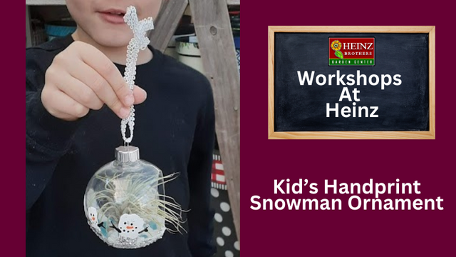 Child holding a snowman handprint ornament created a 'Heinz' workshop banner advertisement in back