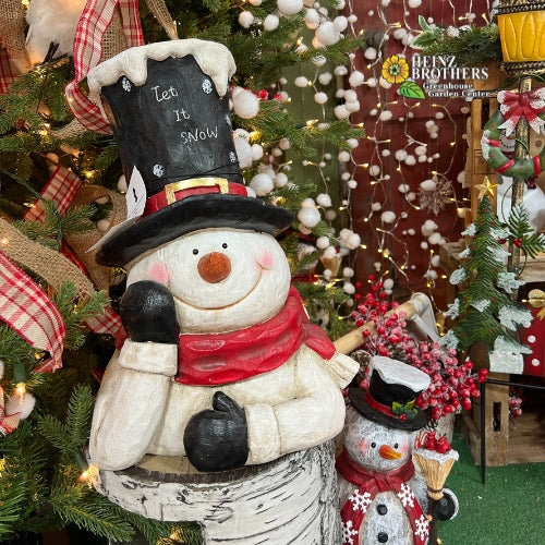 snowman with let it snow on his hat with white pom pom garland