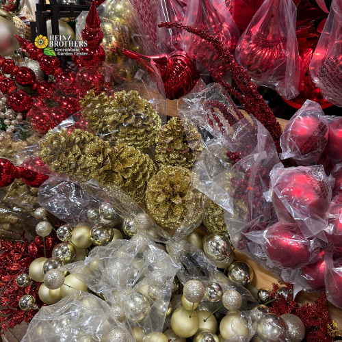 Assorted Christmas ornaments including red, gold, and silver balls and pinecones.
