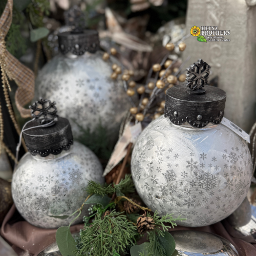 Decorative glass balls with snowflake patterns on a rustic background